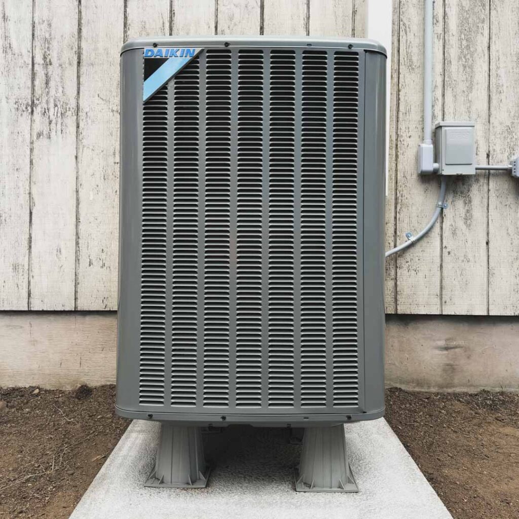 air conditioner repaired unit on concrete block