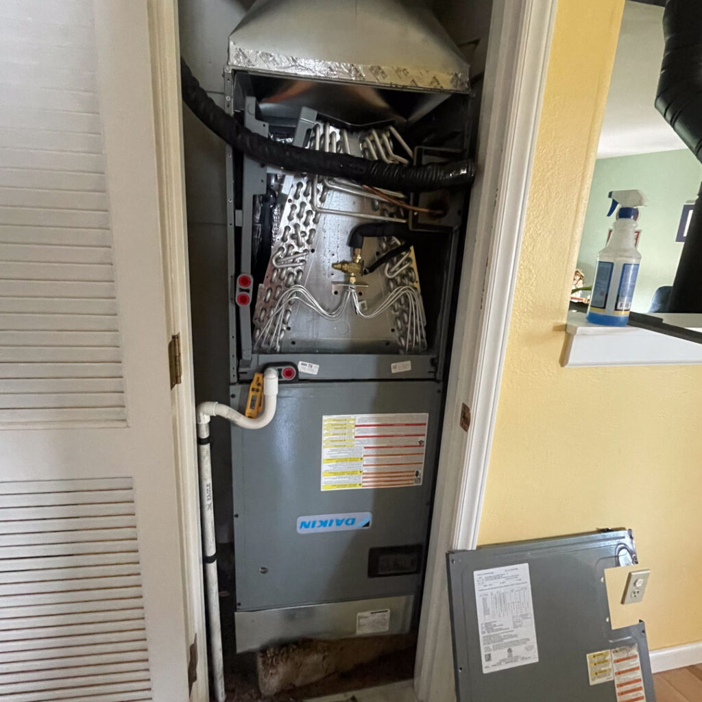 gas furnace in closet being repaired